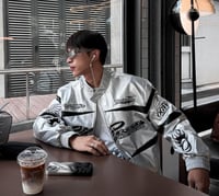 Hellstar's red bomber jacket is decorated with a b...