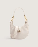 شنطة نسائية بلون أبيض وبمقاس صغير.