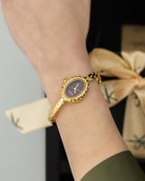 ساعة بيضاوي باللون الذهبي ميناء بني