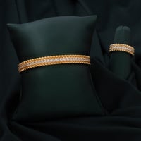 طقم اسوارة وخاتم باللون الذهبي..