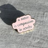 دبوس A nurse is compassion in scrubs