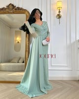 فستان سهرة أخضر فاتح بأكمام مطرزة