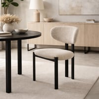 كرسي بتصميم عصري وبسيط، مبطن بقماش بني ناعم مع أرج...