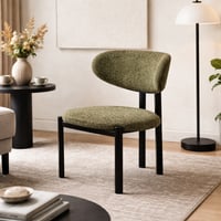 كرسي بتصميم عصري وبسيط، مبطن بقماش اخضر ناعم مع أر...