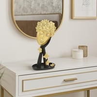 ديكور فني بتصميم وجه ذهبي مع لمسات سوداء يضيف فخام...