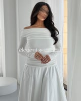 فستان أبيض ساتر أنيق بقصة ناعمة وتصميم ساتر