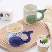 كوب قهوة إبداعي برسمة الدولفين