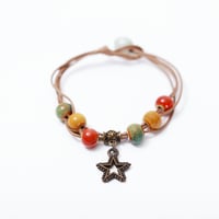 إسوارة الخرز بالنجم المتدلي