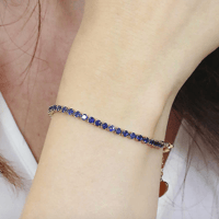 اسوارة تنس ذهبيه بالكرستالات الزرقاء من براند LUCA...