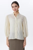 بلوزة بأكمام منفوخة وقماش مخطط ناعم