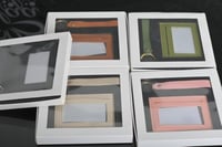 مجموعه(12) محفظة جلد مع الميدلية بي علبة شفاف 17*1...