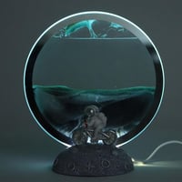 مصباح زجاجي من الرمال المتحركة مع إضاءة دائرية