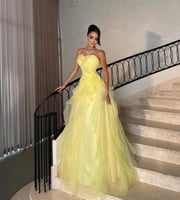 فستان سهرة اصفر اورجنزه