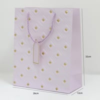 أكياس هدايا مزخرفة بنقاط ذهبية