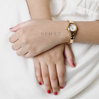 ساعة بنات انيقه ذهبي ومينا ابيض من عمر شهر الى 5 س...