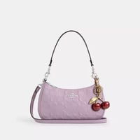 حقيبة كتف كوتش تيري جلد سيغنتشر مع تعليقة قلب تصل...