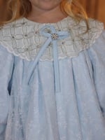 فستان مواليد ازرق فاتح بتفاصيل انيقه