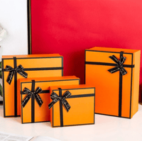 طقم علب هدايا فاخرة برتقالية مزينة بشريط أسود – تص...