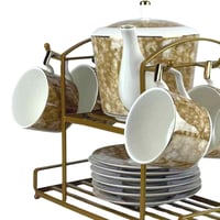 طقم شاي فاخر من البورسلان مع حامل معدني ذهبي