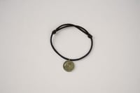 سوار أسود | عملة ذهبية