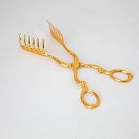 ملقط كيك معدن ذهبي