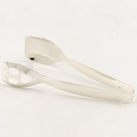 ملقط كيك معدن فضي