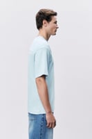 تيشيرت إنترلوك أزرق سماوي للجنسين