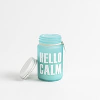 شمعة معطرة في حامل زجاجي بغطاء معدني برائحة جوز ال...