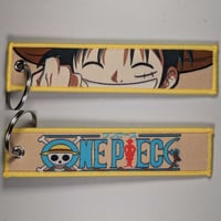 ميدالية لوفي من ون بيس ، صورة مختلفة لكل وجه.