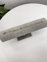 إسوارة TORY BURCH معدن ذهبي بفصوص