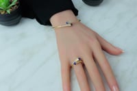 اسوارة مارلي ذهب مع خاتم مزين باللون الازرق تصميم...