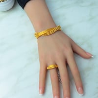 اسوارة مع خاتم ذهب بتصميم الاوميقاء عيار 21