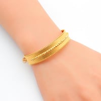 سوارة مع خاتم ذهب عيار 21 وزن 12.2 جرام بتصميم طبق...