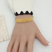 اسوارة بتصميم كرات الدوريكاء الذهبية ذهب عيار 21 و...