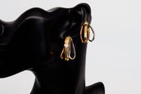 حلق ذهب دائري عيار 18 بتصميم مموج متداخل بوزن 3.7...