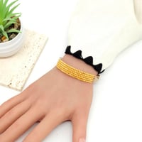 اسوارة بتصميم كرات الدوريكاء الذهبية ذهب عيار 21 و...