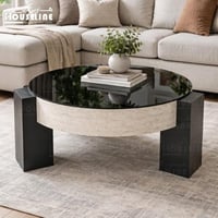 طاولة قهوة مودرن دائرية بسطح زجاجي وقاعدة حجرية أن...