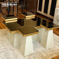 طقم طاولات خدمة مربعة سطح زجاج أسود وحدود ذهبية وق...
