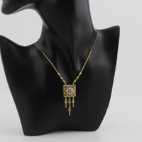 عقد ذهب بتصميم مربع مع خرزة سماوية في المنتصف - عي...