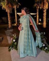 فستان سهرة أخضر فستقي بتصميم راقٍ وشال فاخر