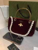 حقيبه يد قوتشي عنابي