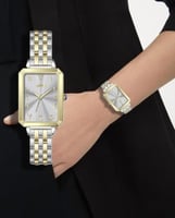 ساعة نسائي بروشا ذهبي فضي مينا رمادي