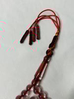 سُبحة بكلايت أحمر شفاف كركوشة.