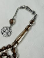 سُبحة بكلايت بني شفاف.