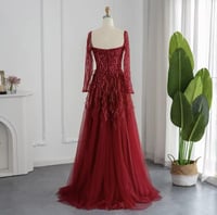 فستان فخم مزين بالريش بأكمام طويلة