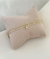 خلخال مؤلف من سلسلتين مع تعليقة بشكل نجمة مطلي ذهب...