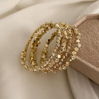 مجموعة من أربع أساور مرنة مطلية ذهب. MB-214