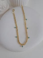 خلخال مع تعليقات بشكل خرزات زرقاء مطلي ذهب. MA-016