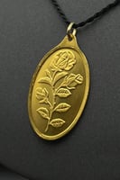 سبيكة ذهب وزن نصف اونصة عيار 24 شكل بيضاوي مع عروه