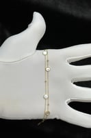 اسوارة شوطين دائري ذهب مع صدف ابيض عيار 18 وزن 1.5...